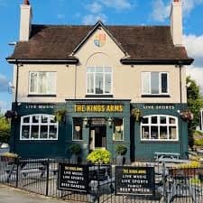 The King's Arms, Redditch, today. A two-storey pub in cream and green with banners advertising live music and live sport.